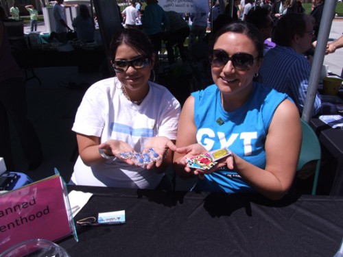 Marcy Cllayson and Talia Perez distribute condoms at Planned Parenthood booth