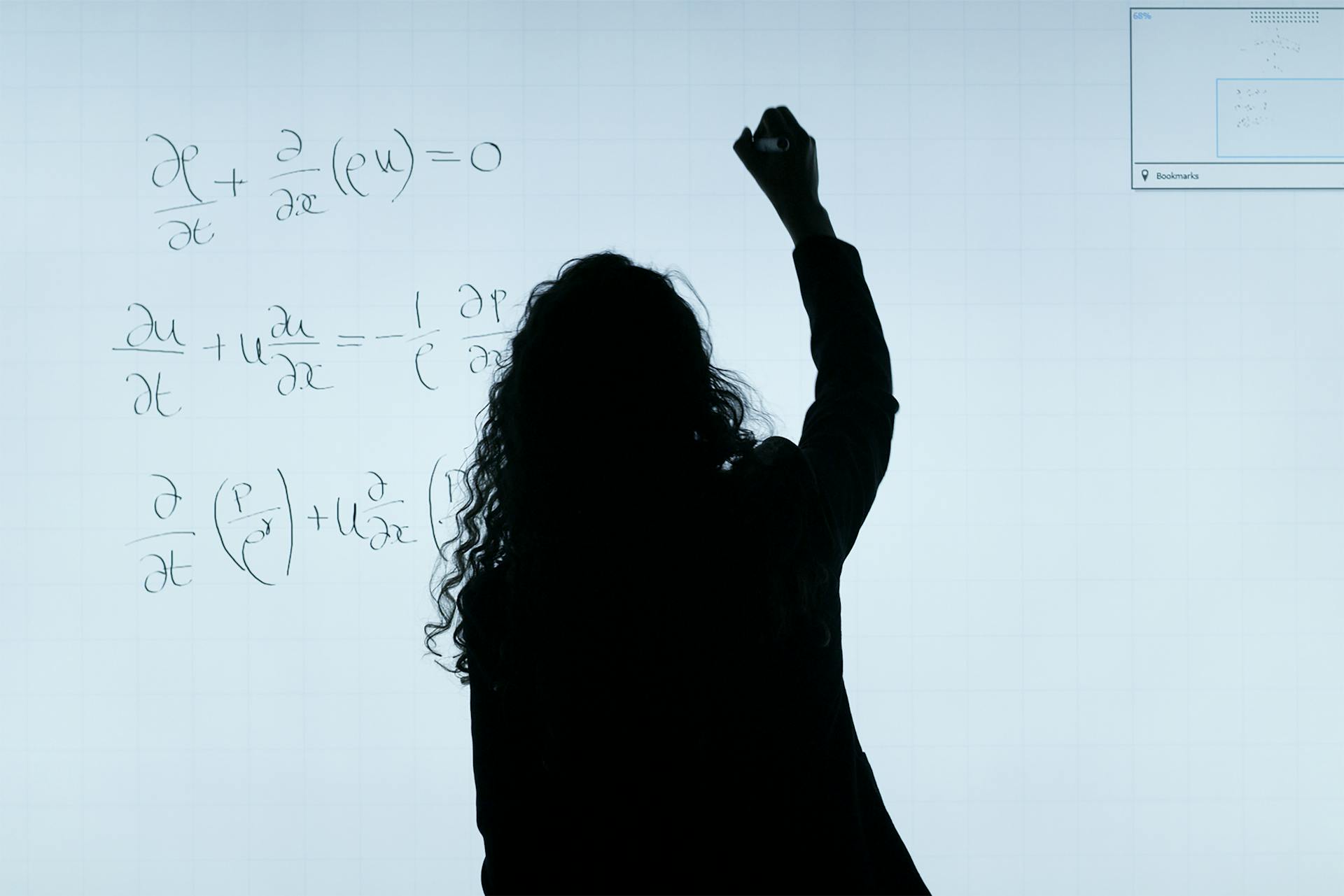 Person writing complex mathematical equations on a large whiteboard or screen.
