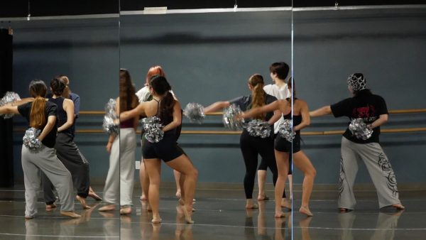 Dancers in Mileigh Nelson's pom piece run the full routine at the start of rehearsal to warm up.