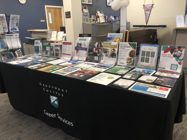 The Career Services Center table of Hand-Outs of Opportunities and Scheduled Workshops
