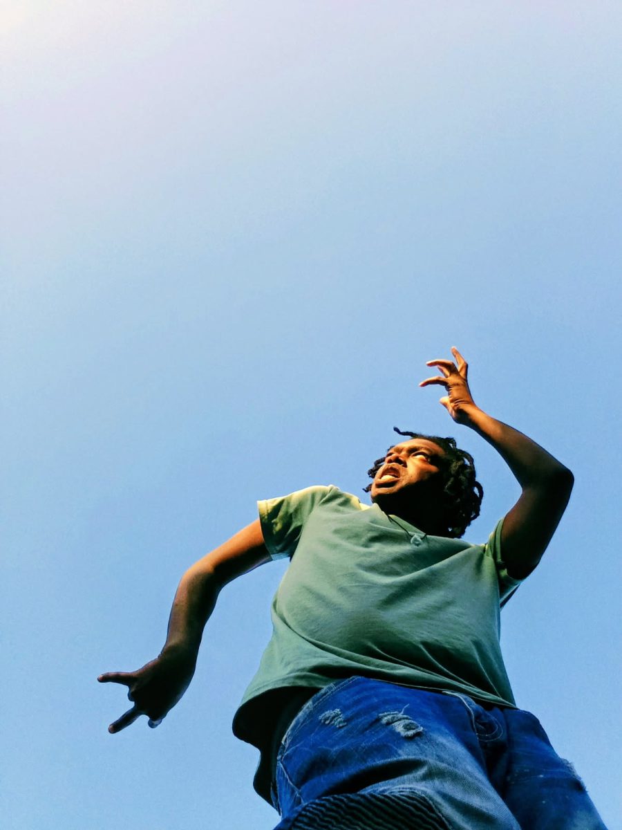 President of Rhythm Cultural Dance Club taking a dance pose.